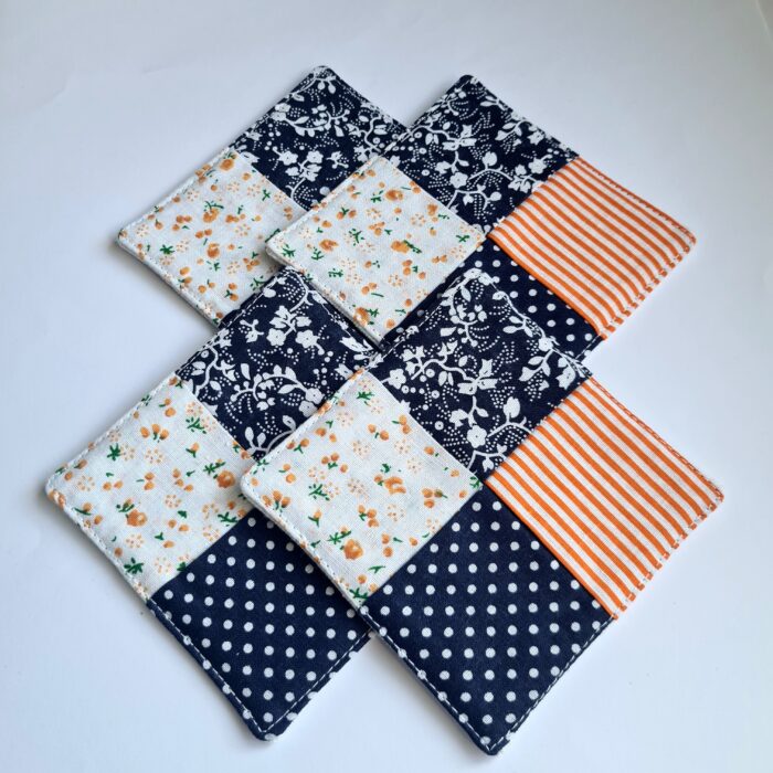 Underlägg - fyrkantiga orange/svarta 4-pack
